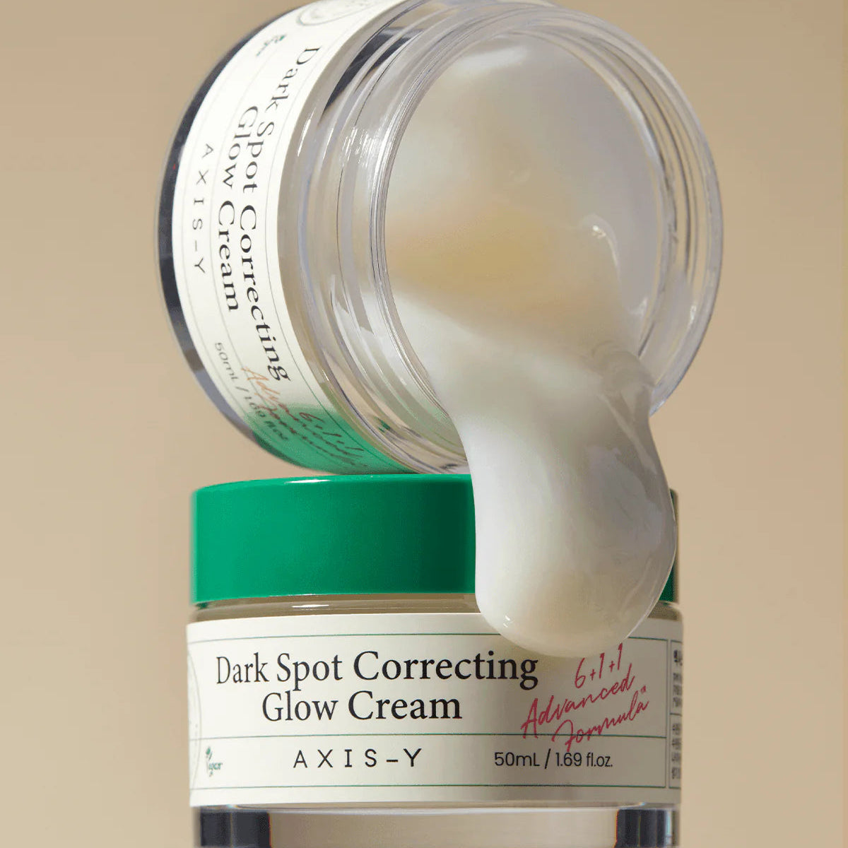AXIS-Y Dark Spot Correcting Glow Cream jar with cream oozing out on a beige background