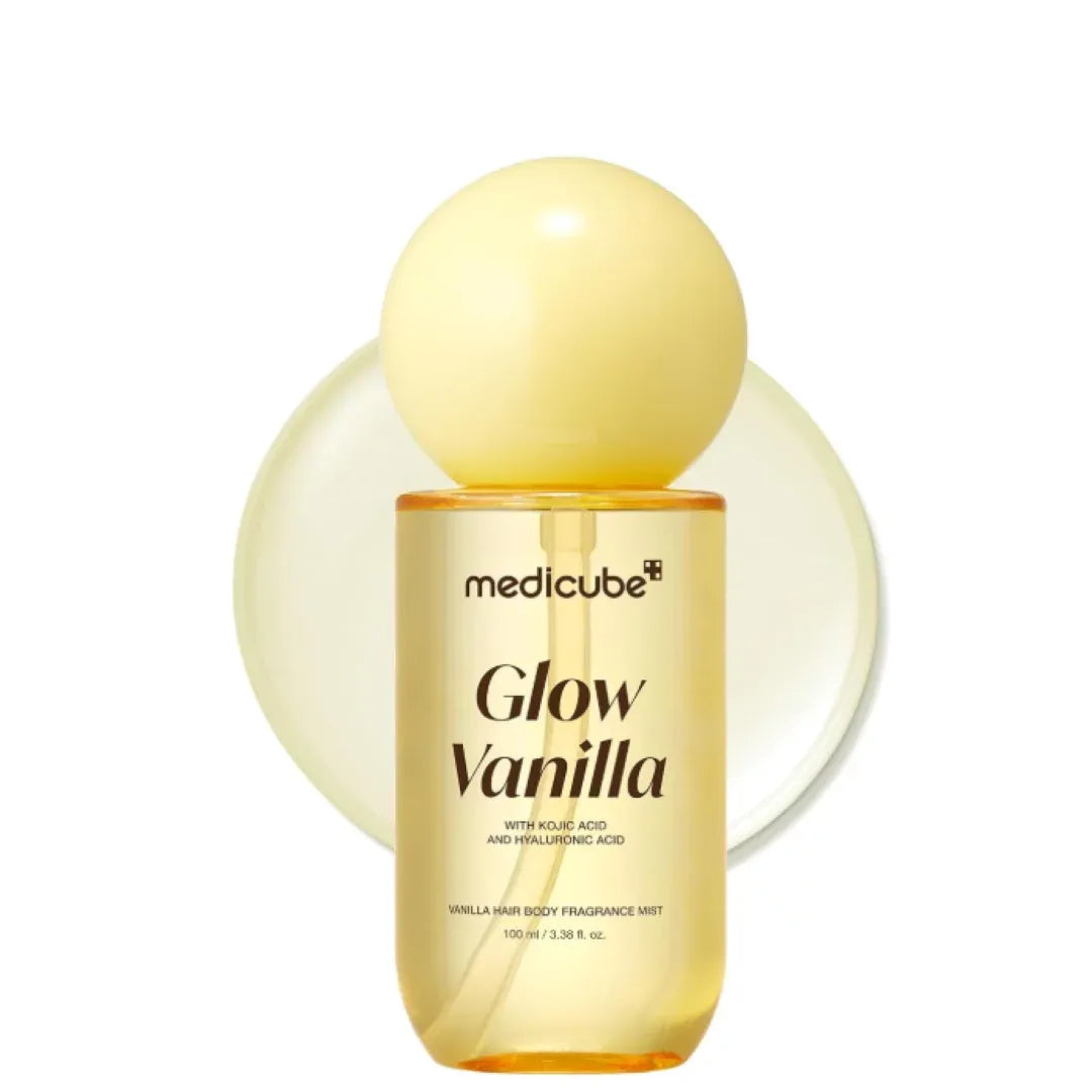 A bottle of medicube Glow Vanilla body fragrance mist with a pale yellow spherical cap, set against a white background with a matching pale yellow circular graphic behind it.