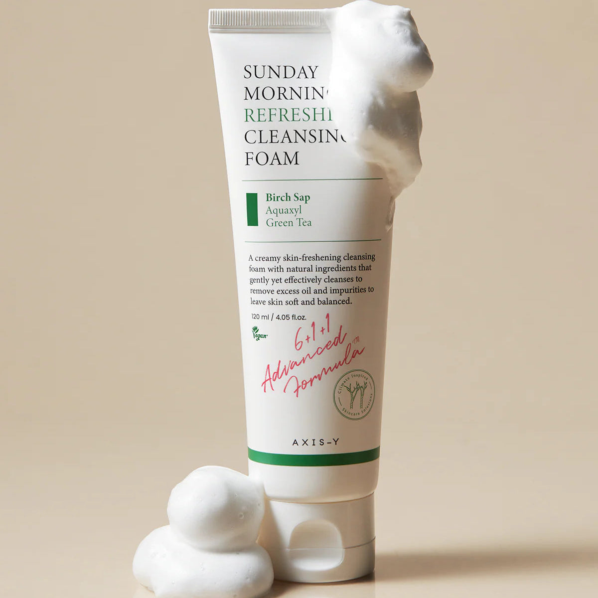 Tube of Sunday Morning Refreshing Cleansing Foam with foam on top against a beige background