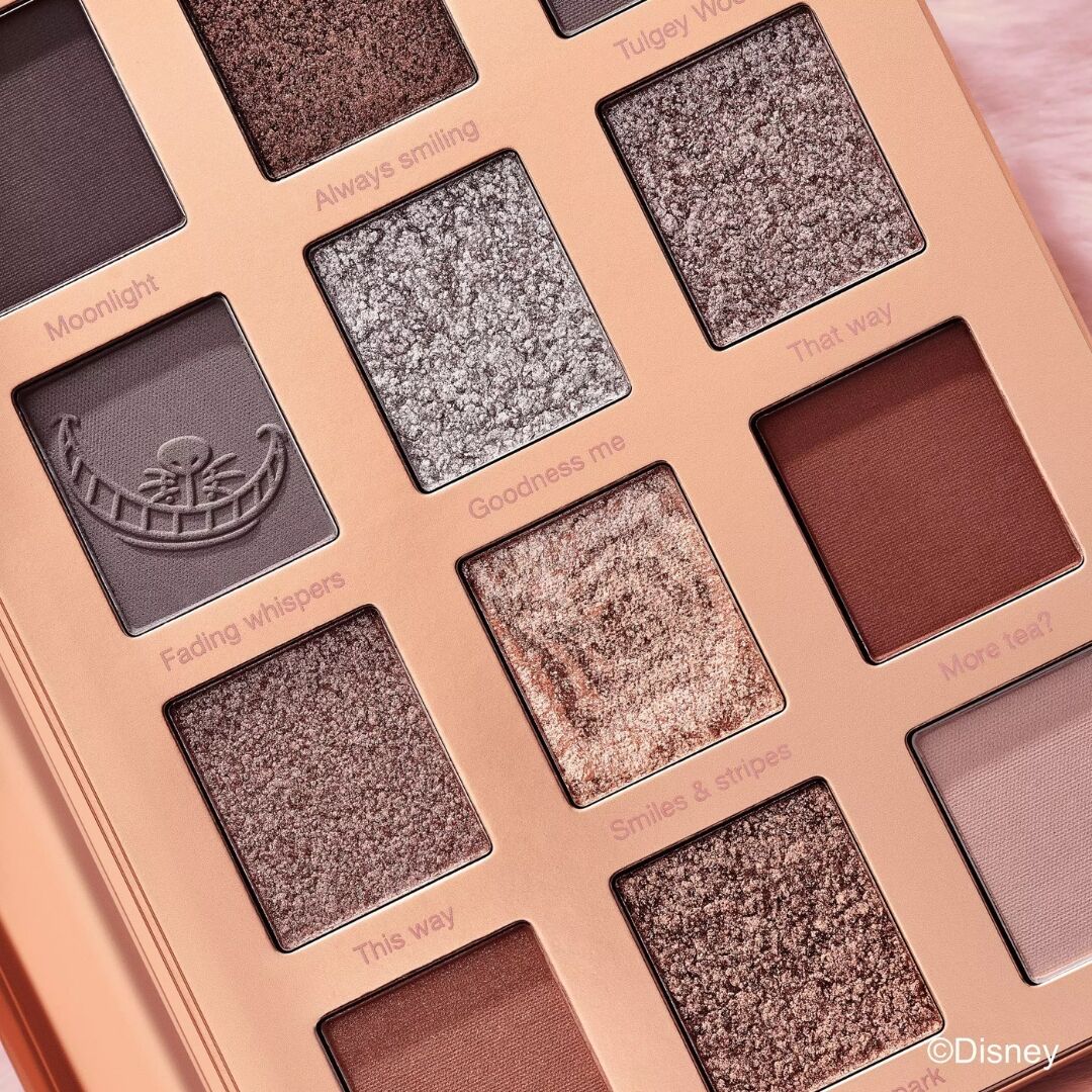 Various eyeshadow shades in a grid layout of Essence Disney Alice in Wonderland eyeshadow palette